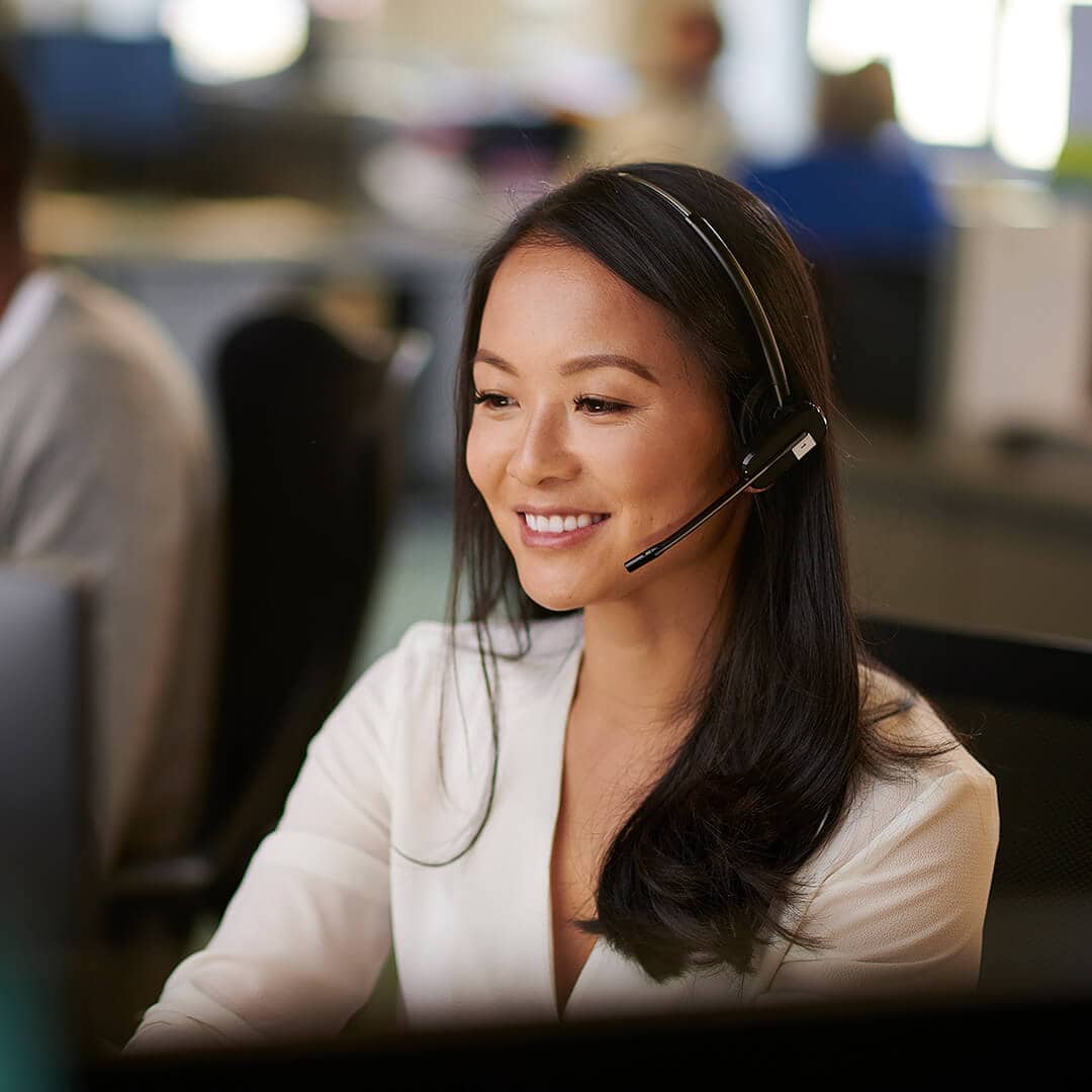 Young friendly smiling woman in a call center