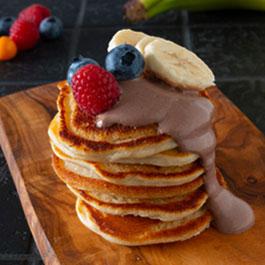 Vegan pancakes with chocolate cream and berries