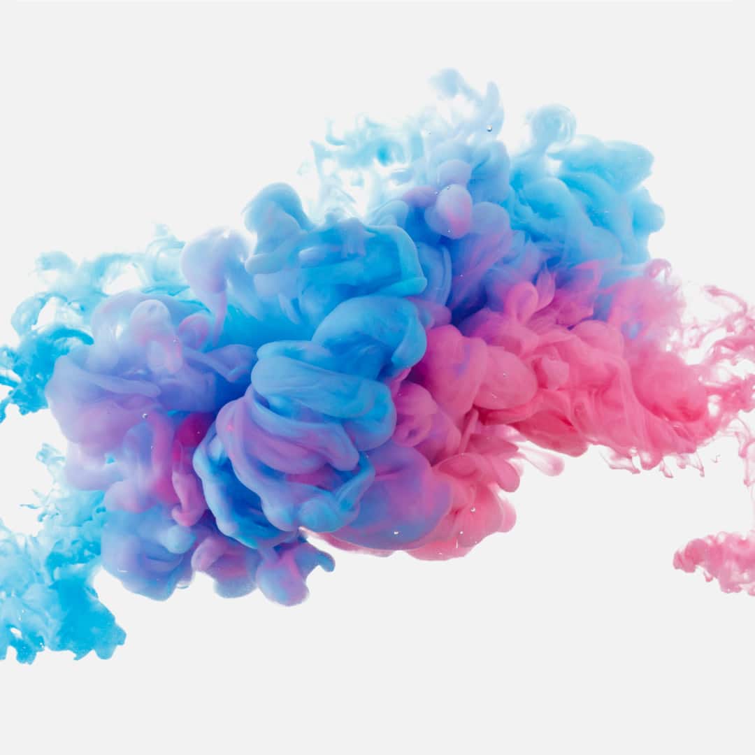 Colorful ink swirling in water on a white background