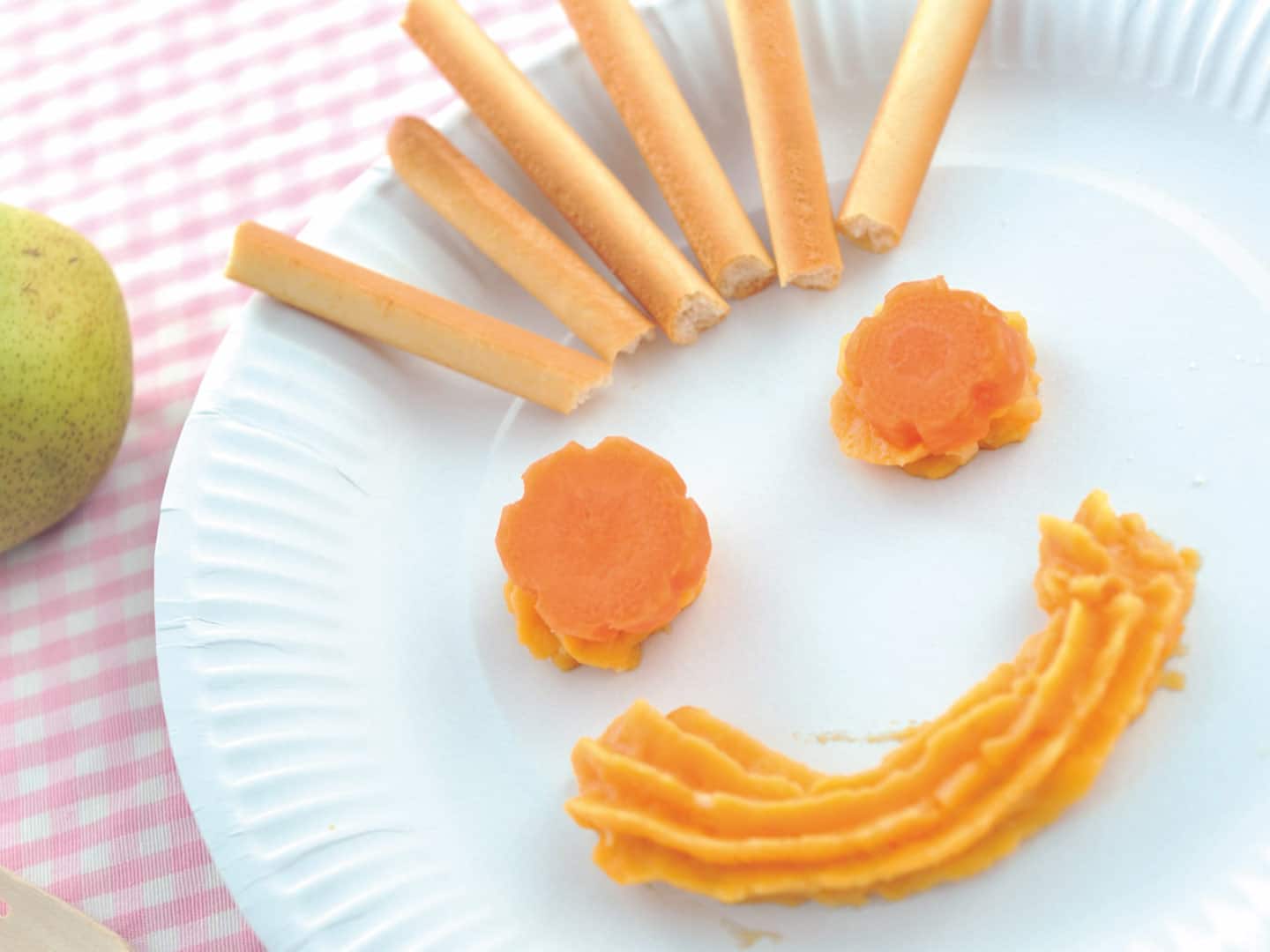 9-12 months: Thick carrot puree shaped like a smiling face