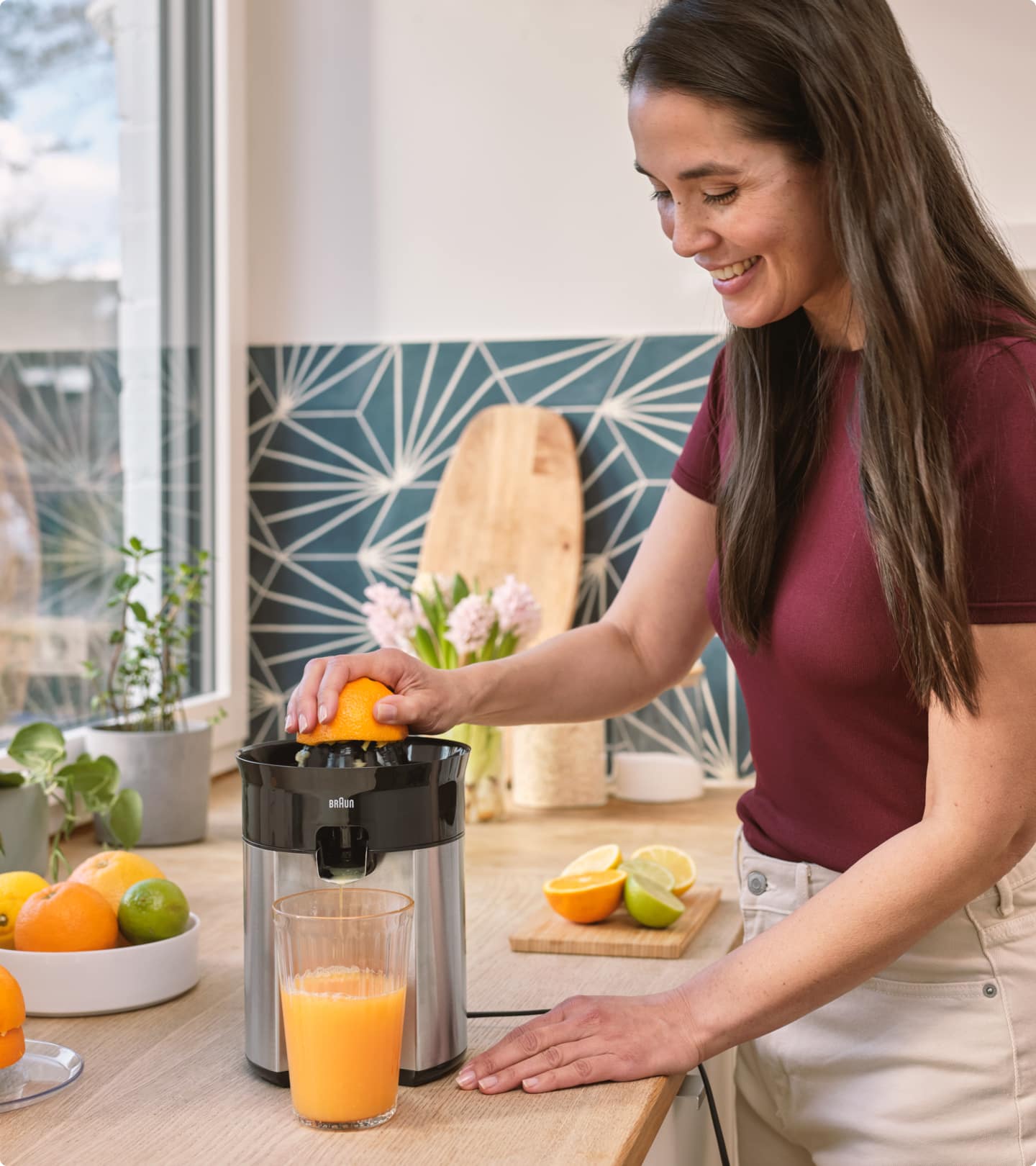 Woman preparing fresh orange juice with Braun CitrusQuick 5 Citrus juicer 