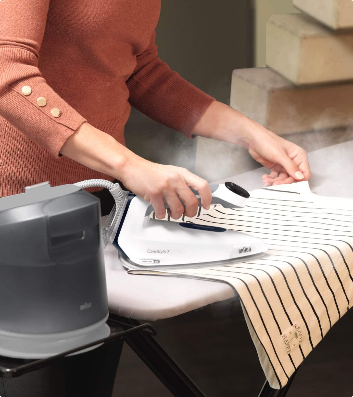 Close up of a Woman, ironing a shirt with Braun CareStyle 7 Steam generator iron