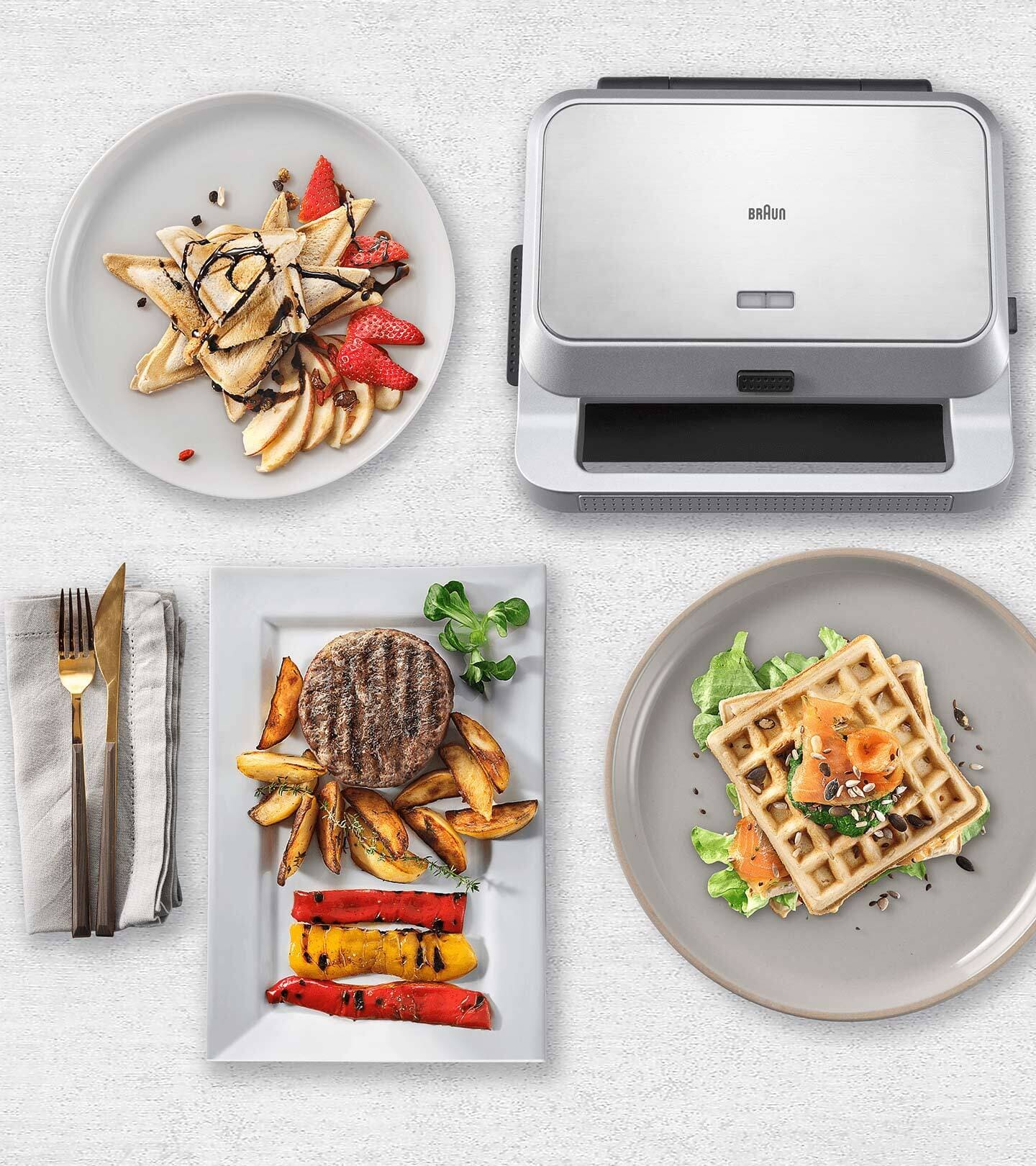 Braun SnackMaker 5 and plates with sandwitches, waffles and freshly grilled vegetables.
